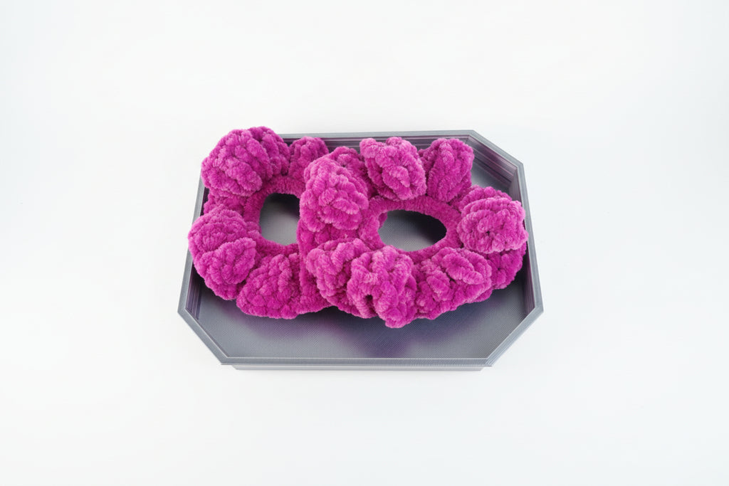 Purple hair scrunchies on a wooden surface