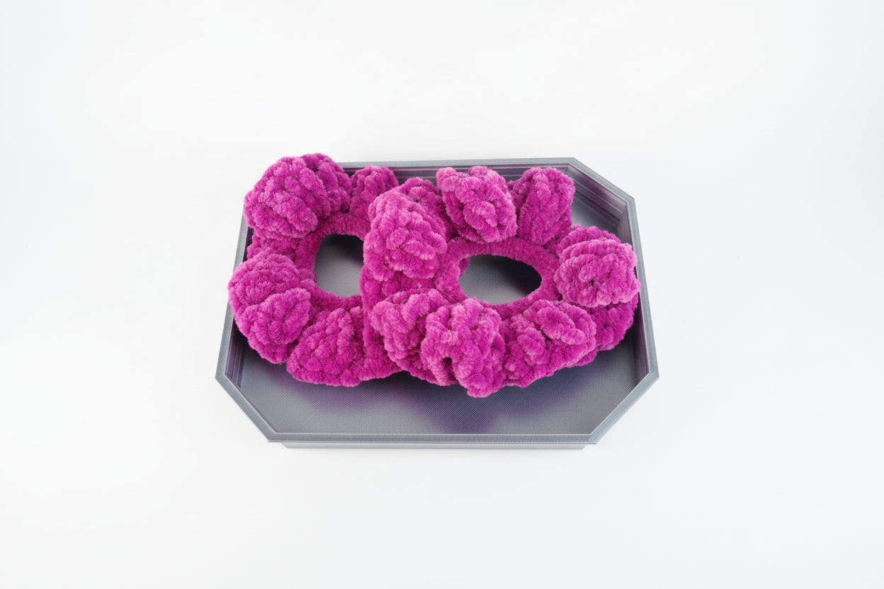Purple hair scrunchies on a wooden surface